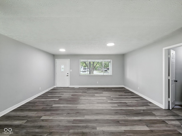 2853 S State Ave, Indianapolis, IN 46203 - unfurnished living room with wood finished floors, recessed lighting, and a textured ceiling
