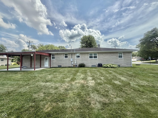 605 Redding Rd, Seymour, IN 47274 - rear view of property with stone siding, a lawn, and a patio