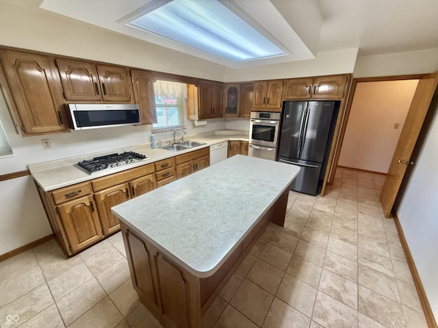 605 Redding Rd, Seymour, IN 47274 - kitchen with appliances with stainless steel finishes, light countertops, a warming drawer, brown cabinetry, and a kitchen island