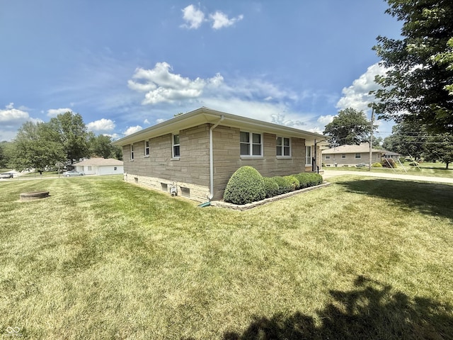 605 Redding Rd, Seymour, IN 47274 - view of side of property featuring stone siding and a lawn
