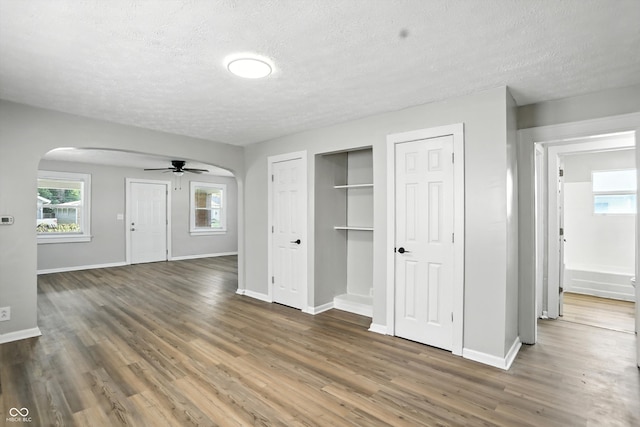 3609 N Keystone Ave, Indianapolis, IN 46218 - unfurnished bedroom featuring arched walkways, a textured ceiling, two closets, and wood finished floors