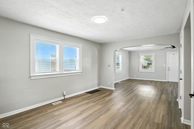 3609 N Keystone Ave, Indianapolis, IN 46218 - spare room with arched walkways, wood finished floors, a textured ceiling, and ceiling fan