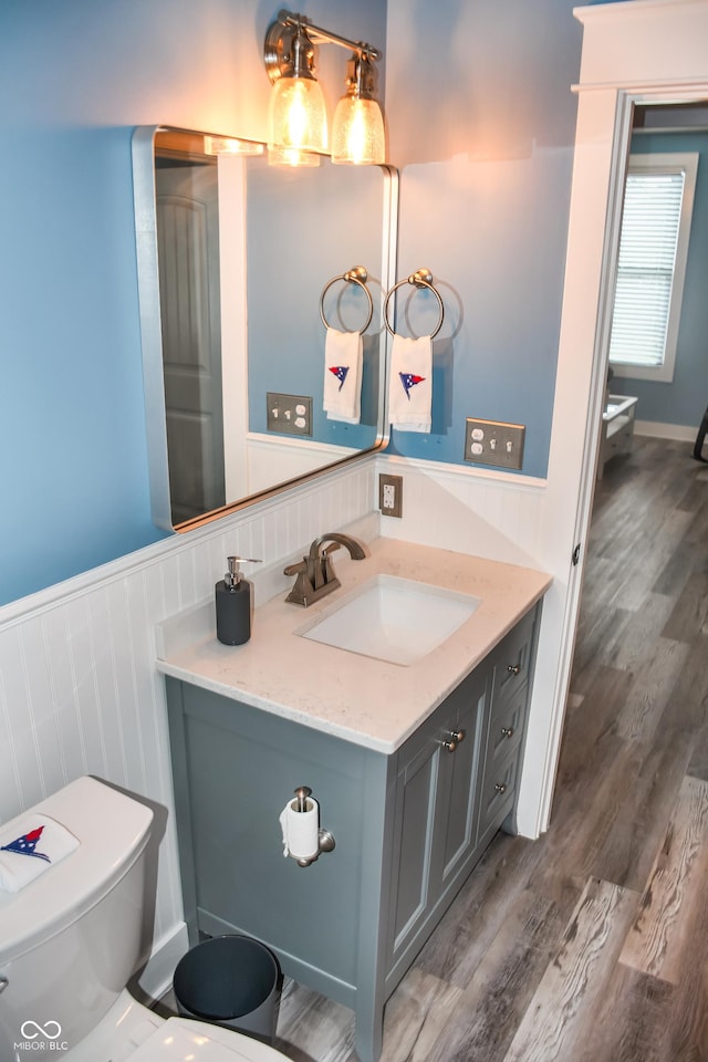 206 Olive St, Arcadia, IN 46030 - bathroom featuring vanity, a wainscoted wall, and wood finished floors