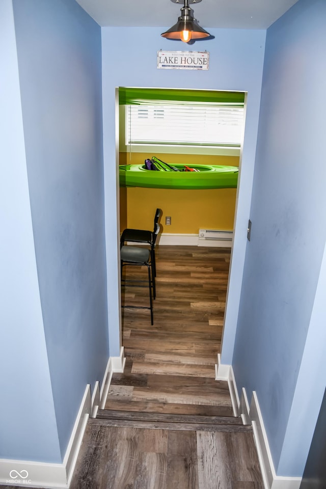 206 Olive St, Arcadia, IN 46030 - staircase with wood finished floors and a baseboard radiator