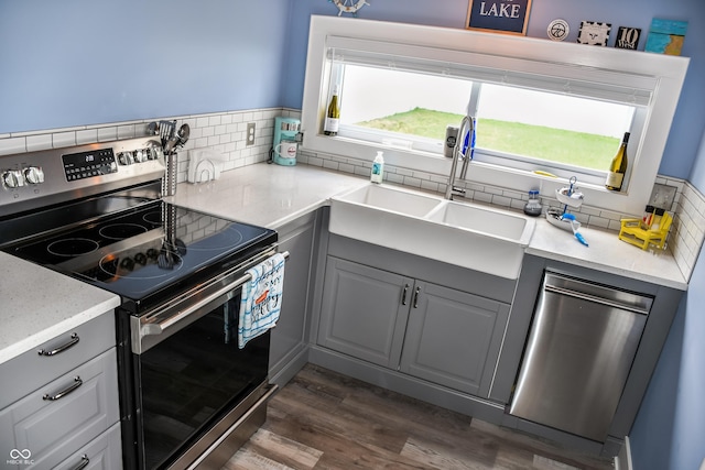 206 Olive St, Arcadia, IN 46030 - kitchen with stainless steel appliances, gray cabinets, dark wood-type flooring, and tasteful backsplash