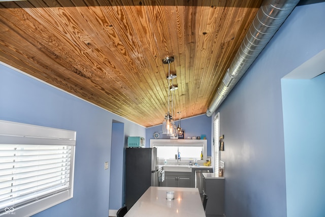206 Olive St, Arcadia, IN 46030 - kitchen with freestanding refrigerator, wooden ceiling, decorative light fixtures, and gray cabinets