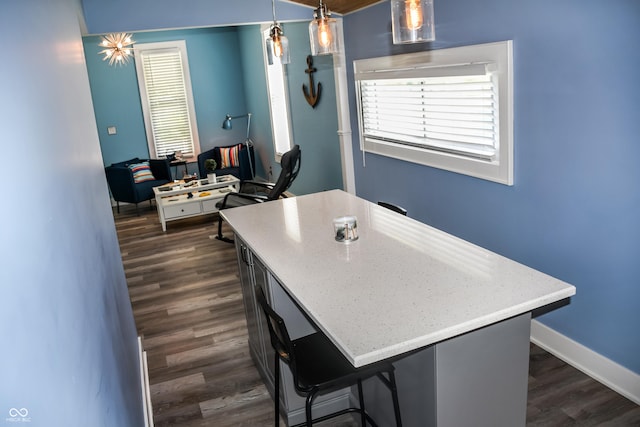 206 Olive St, Arcadia, IN 46030 - kitchen with dark wood-style flooring, decorative light fixtures, light stone counters, and a kitchen island