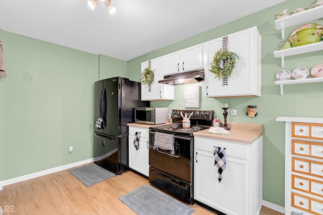 1912 Blue Pine Ln, Indianapolis, IN 46231 - kitchen with black appliances, under cabinet range hood, white cabinetry, light wood-style flooring, and light countertops