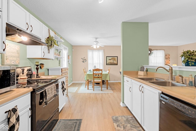 1912 Blue Pine Ln, Indianapolis, IN 46231 - kitchen with black appliances, under cabinet range hood, white cabinets, light wood-style flooring, and ceiling fan