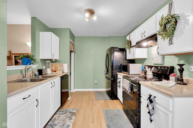 1912 Blue Pine Ln, Indianapolis, IN 46231 - kitchen featuring black appliances, under cabinet range hood, light wood-style floors, white cabinets, and a textured ceiling