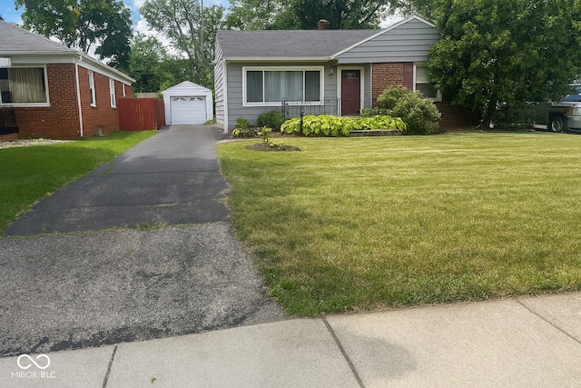 3642 N Dequincy St, Indianapolis, IN 46218 - ranch-style home featuring driveway, brick siding, an outdoor structure, and a front yard