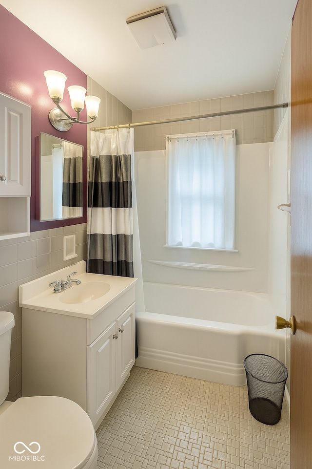 3642 N Dequincy St, Indianapolis, IN 46218 - full bathroom featuring vanity, shower / bath combo, and tile walls
