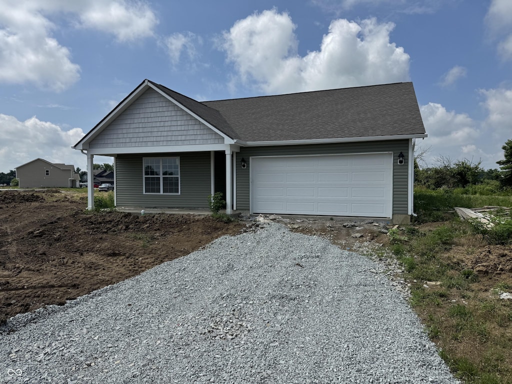 1063 Lake Ct, Shirley, IN 47384 - view of front facade featuring driveway, a garage, and covered porch