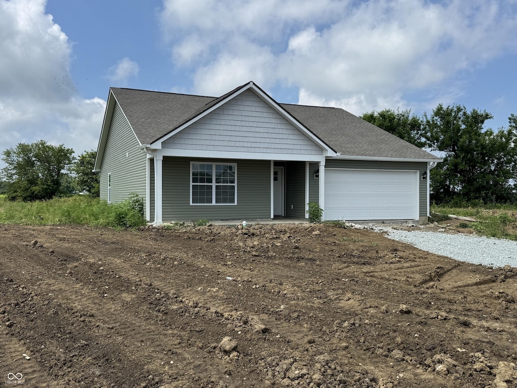 1063 Lake Ct, Shirley, IN 47384 - single story home with covered porch, an attached garage, driveway, and roof with shingles