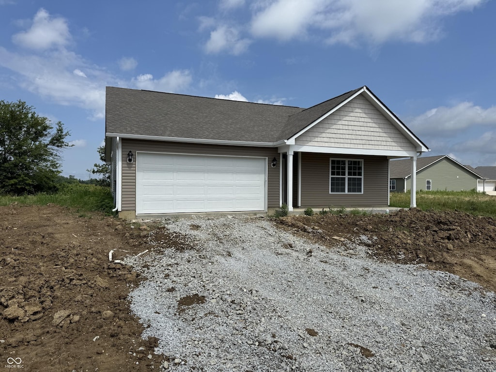 1105 Lake Dr, Shirley, IN 47384 - view of front of property with an attached garage, driveway, and a shingled roof