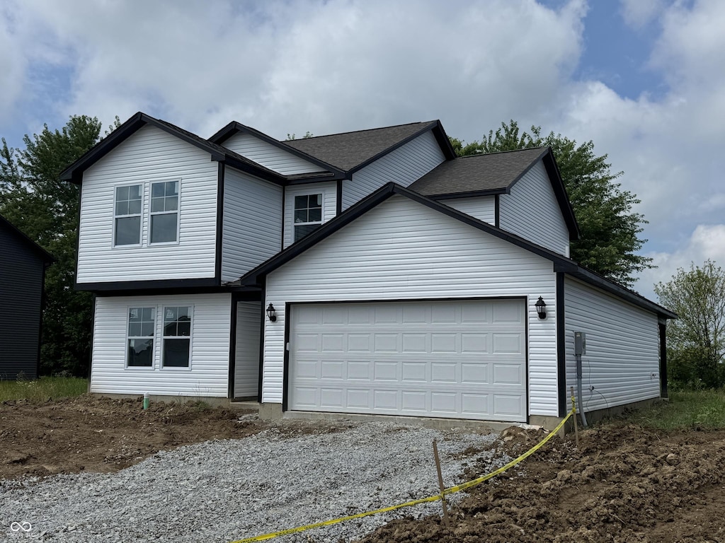 1123 Lake Dr, Shirley, IN 47384 - traditional-style home featuring an attached garage and gravel driveway