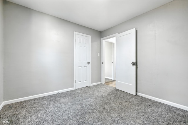 452 N Fenton Ave, Indianapolis, IN 46219 - unfurnished bedroom featuring carpet and baseboards