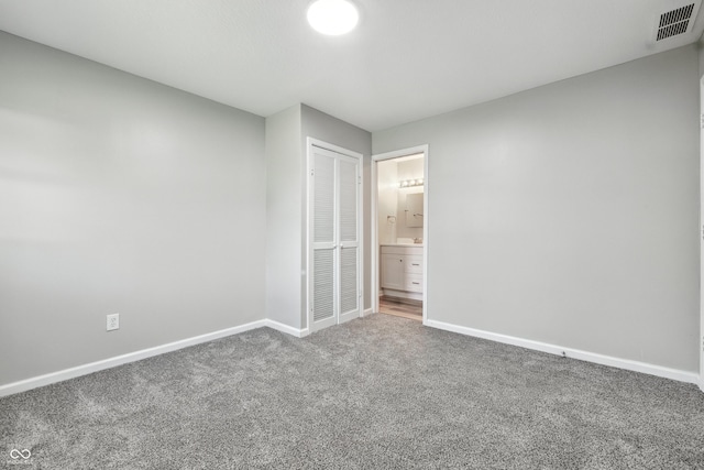452 N Fenton Ave, Indianapolis, IN 46219 - unfurnished bedroom featuring carpet, a closet, and ensuite bathroom