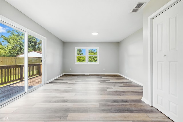 452 N Fenton Ave, Indianapolis, IN 46219 - unfurnished bedroom featuring access to outside, light wood-type flooring, a closet, and recessed lighting
