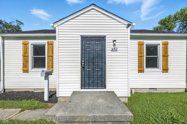 452 N Fenton Ave, Indianapolis, IN 46219 - property entrance featuring crawl space, a shingled roof, and a yard