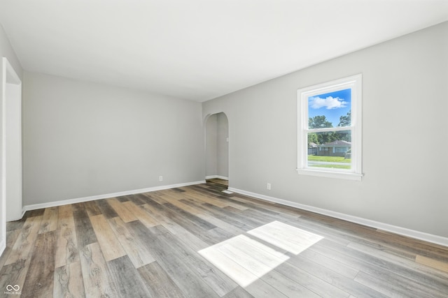 452 N Fenton Ave, Indianapolis, IN 46219 - unfurnished room with arched walkways and wood finished floors