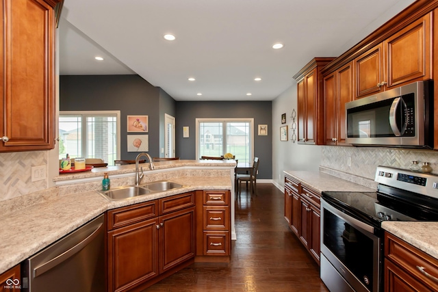 1976 Austin James Ln, Seymour, IN 47274 - kitchen featuring stainless steel appliances, a peninsula, light countertops, recessed lighting, and dark wood-style flooring