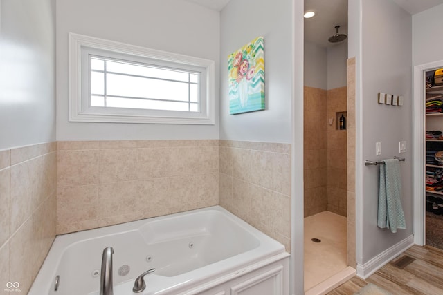 1976 Austin James Ln, Seymour, IN 47274 - full bathroom featuring a whirlpool tub, a tile shower, and a walk in closet