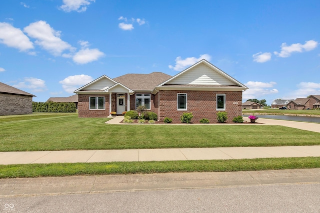 1976 Austin James Ln, Seymour, IN 47274 - ranch-style house with brick siding, a front lawn, and a water view