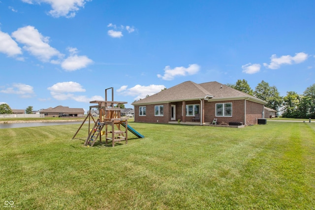 1976 Austin James Ln, Seymour, IN 47274 - back of property featuring a playground, brick siding, and a lawn