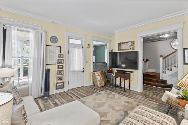 38 W Main St, Brownsburg, IN 46112 - living room with wood finished floors, healthy amount of natural light, stairs, and ornamental molding