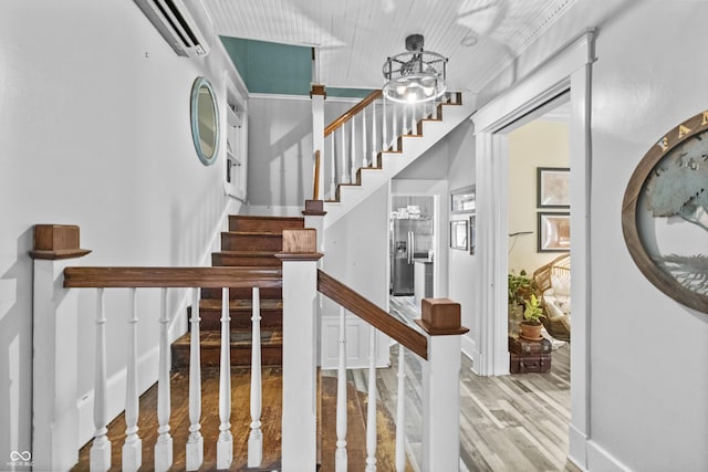 38 W Main St, Brownsburg, IN 46112 - stairway with an AC wall unit, wood finished floors, and a chandelier