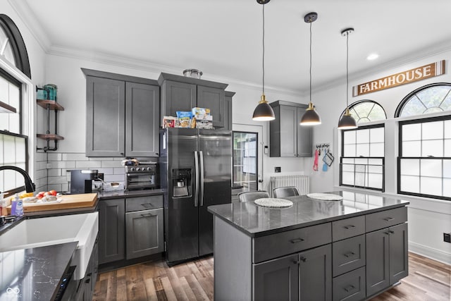 38 W Main St, Brownsburg, IN 46112 - kitchen featuring refrigerator with ice dispenser, radiator heating unit, wood finished floors, crown molding, and backsplash