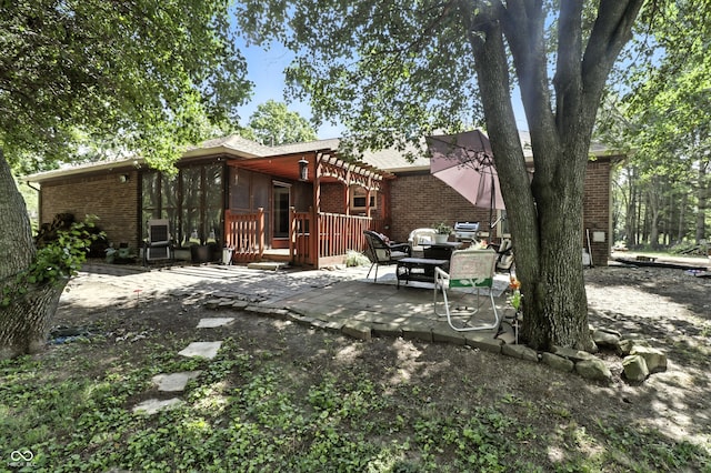 1346 N Buck Creek Rd, Greenfield, IN 46140 - rear view of house featuring brick siding, a patio, and a wooden deck