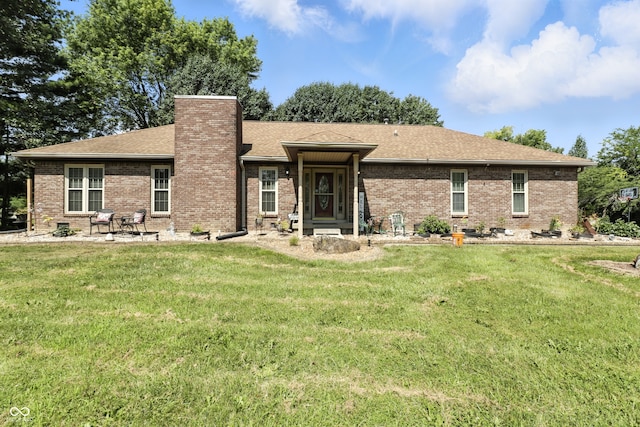 1346 N Buck Creek Rd, Greenfield, IN 46140 - view of front of house featuring a chimney, a front yard, and brick siding