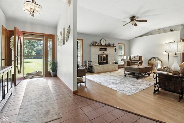 1346 N Buck Creek Rd, Greenfield, IN 46140 - entryway with a ceiling fan, tile patterned floors, a fireplace, vaulted ceiling, and a chandelier
