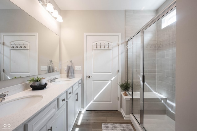 2856 Old Rosebud Ln, Westfield, IN 46074 - bathroom featuring double vanity, a stall shower, and wood finished floors