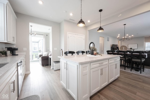 2856 Old Rosebud Ln, Westfield, IN 46074 - kitchen with a chandelier, open floor plan, light wood finished floors, white cabinetry, and recessed lighting