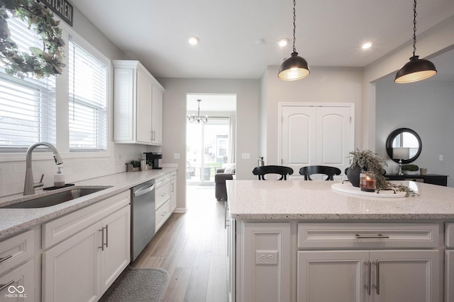2856 Old Rosebud Ln, Westfield, IN 46074 - kitchen featuring stainless steel dishwasher, light wood-style flooring, white cabinetry, decorative light fixtures, and recessed lighting