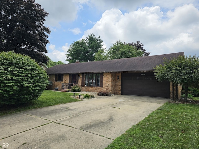 2239 Chevelle Ct, Anderson, IN 46012 - ranch-style home with brick siding, a garage, a front lawn, and driveway
