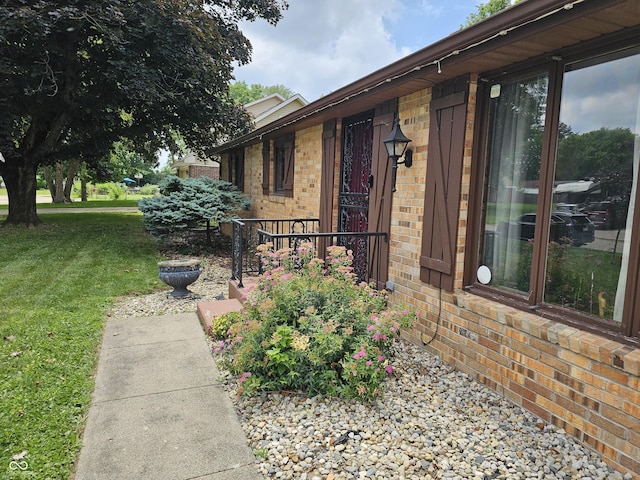 2239 Chevelle Ct, Anderson, IN 46012 - entrance to property with brick siding and a lawn