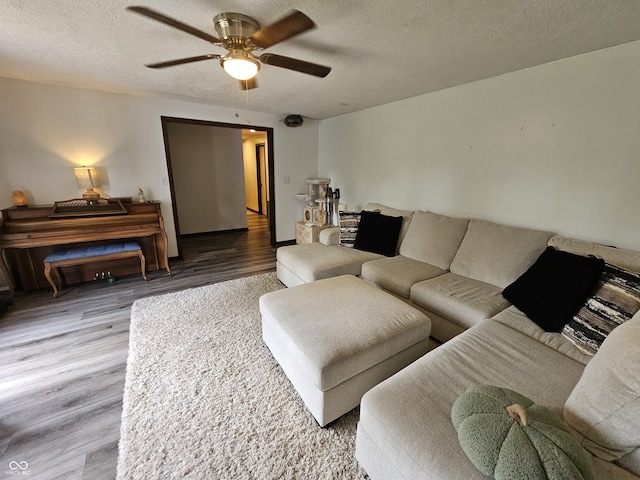 2239 Chevelle Ct, Anderson, IN 46012 - living room featuring wood finished floors, a ceiling fan, and a textured ceiling