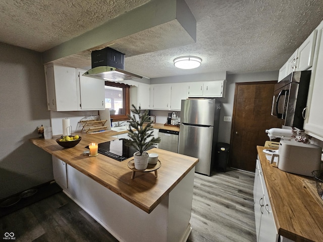 2239 Chevelle Ct, Anderson, IN 46012 - kitchen featuring wood counters, stainless steel appliances, light wood-style floors, a peninsula, and a textured ceiling