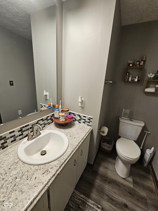 2239 Chevelle Ct, Anderson, IN 46012 - bathroom with decorative backsplash, wood finished floors, vanity, and a textured ceiling