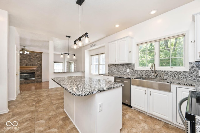 8909 Carnation Dr, Noblesville, IN 46060 - kitchen with stainless steel dishwasher, range, plenty of natural light, a center island, and recessed lighting
