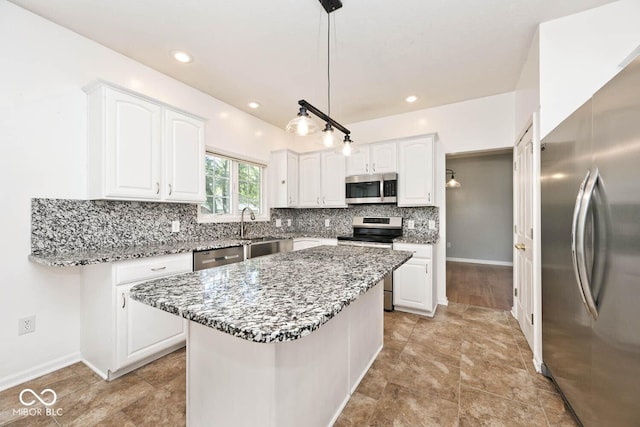 8909 Carnation Dr, Noblesville, IN 46060 - kitchen featuring stainless steel appliances, light stone countertops, white cabinetry, tasteful backsplash, and recessed lighting
