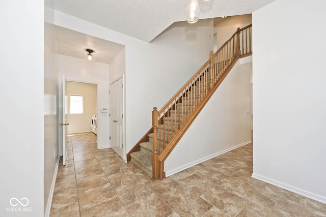 8909 Carnation Dr, Noblesville, IN 46060 - staircase featuring washer and clothes dryer and baseboards