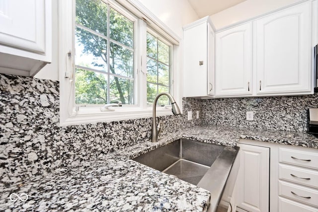 8909 Carnation Dr, Noblesville, IN 46060 - kitchen featuring tasteful backsplash, white cabinetry, and light stone counters