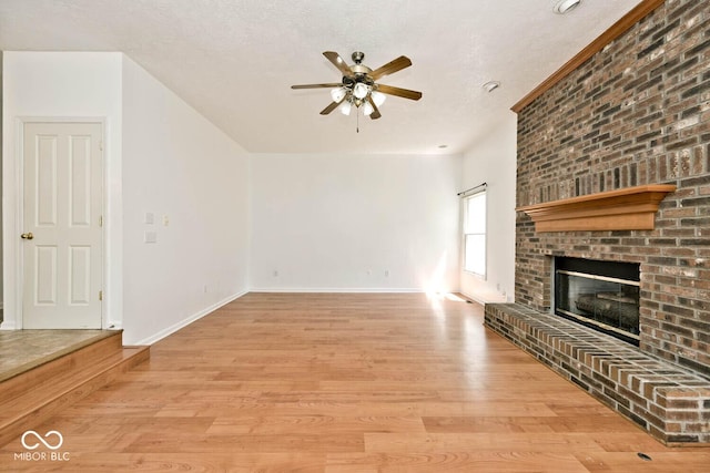8909 Carnation Dr, Noblesville, IN 46060 - unfurnished living room featuring a ceiling fan, light wood-style floors, and a fireplace
