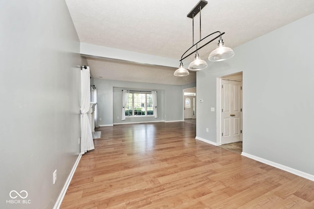 8909 Carnation Dr, Noblesville, IN 46060 - unfurnished living room featuring light wood-type flooring and a textured ceiling
