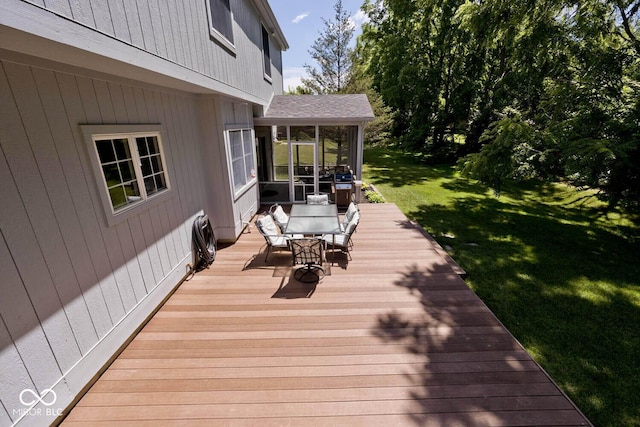 8909 Carnation Dr, Noblesville, IN 46060 - deck featuring a sunroom, outdoor dining area, a yard, and grilling area